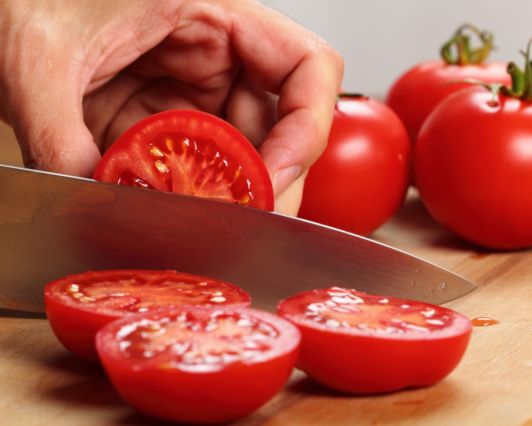 cortando tomates para añadir al sofrito